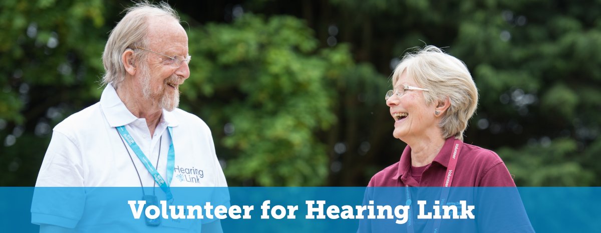 A man and a woman laughing together. text is Volunteer for Hearing Link