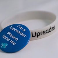 Lipreader wristband and badge