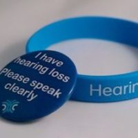 Hearing loss wristband and badge