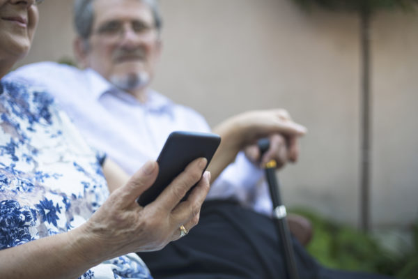 Senior adult couple using smart phone-close up