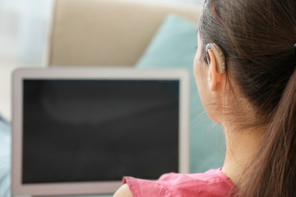 Woman with hearing loss using a laptop