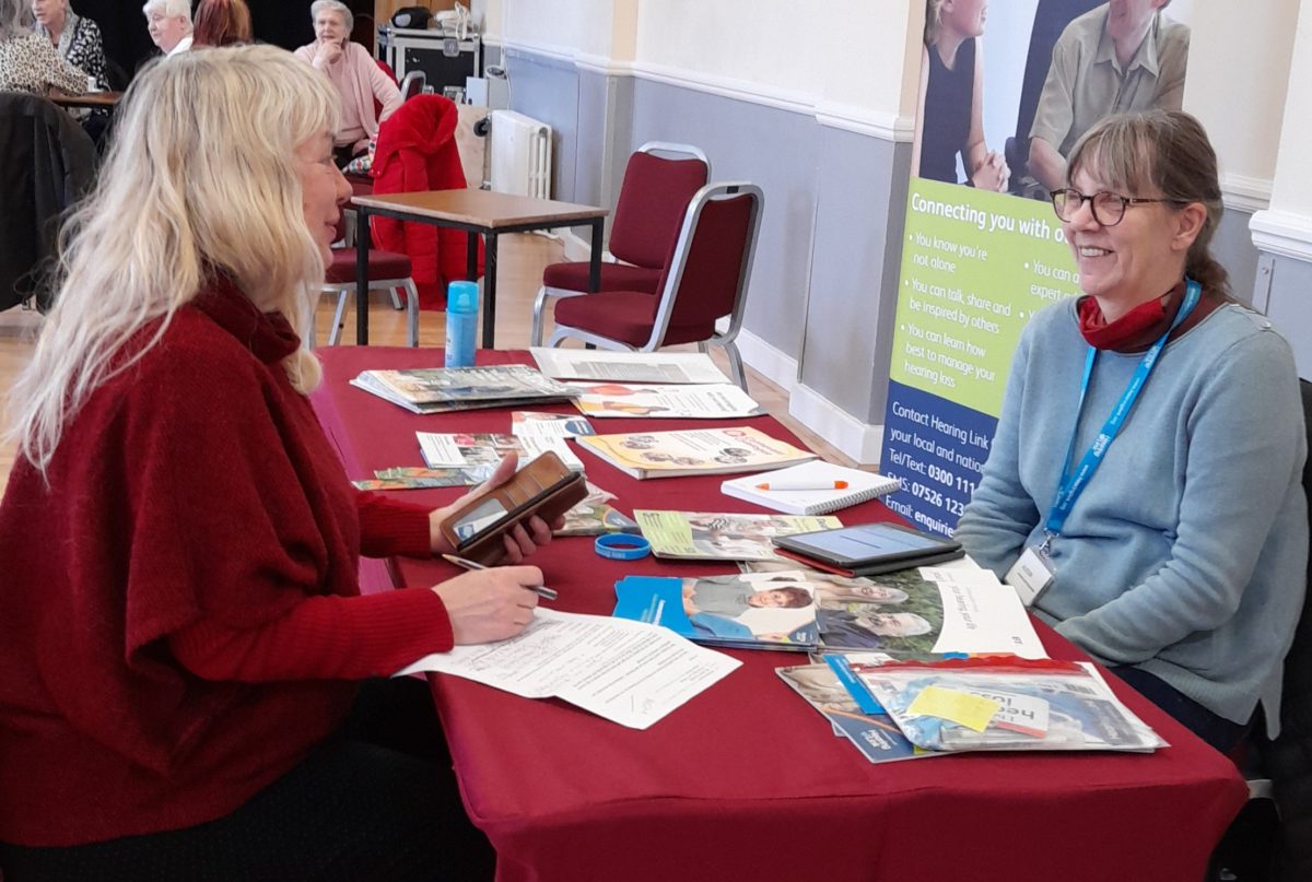 Peer support volunteer offering advice at a Hearing Support Session