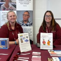 Hearing Link Services staff at an information event