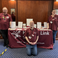 Three peer support volunteers providing guidance for hearing loss